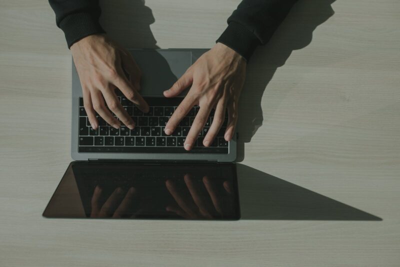 A man typing on a laptop. Depiction of a cyber security concept.